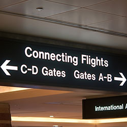 An airport sign directing travellers with connecting flights to where their gates are.