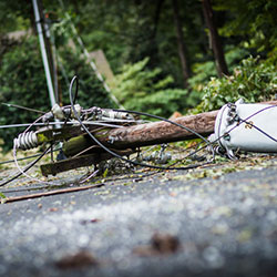 A hydro pole and wires down on the street after a severe storm.