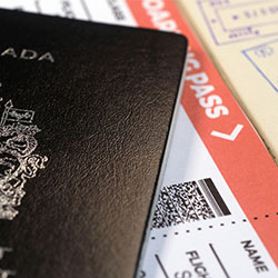 A passport and boarding pass on a desk.